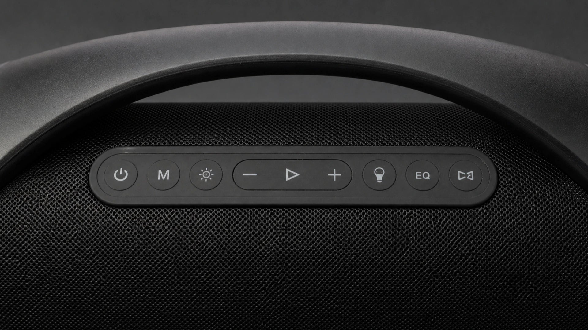 Close top view of the physical Sonic Boom Max control buttons, handle, and grille texture
