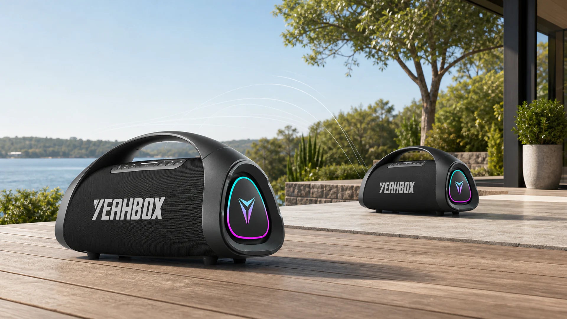 Exactly two identical Sonic Boom Max speakers paired across a natural outdoor listening space