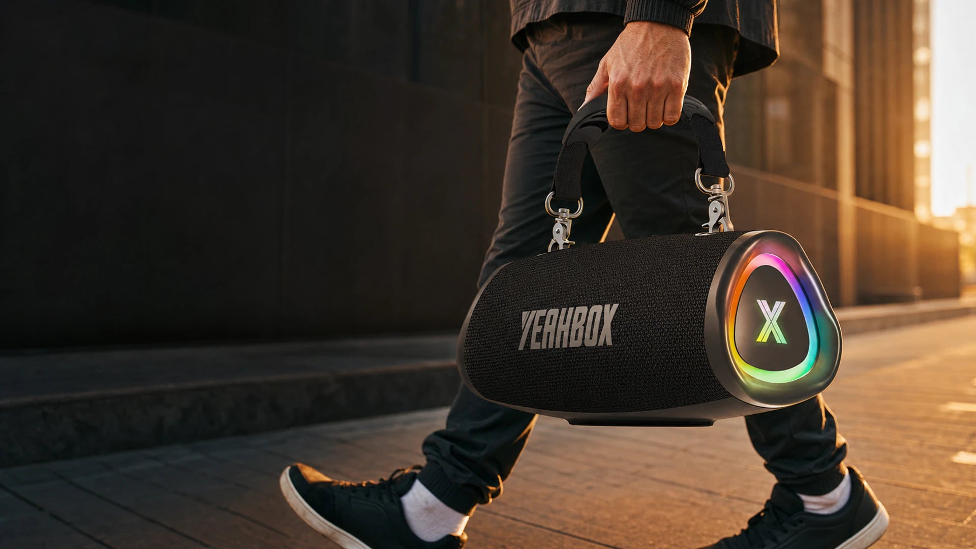 Person carrying a black Sonic Boom Pop by its short detachable strap