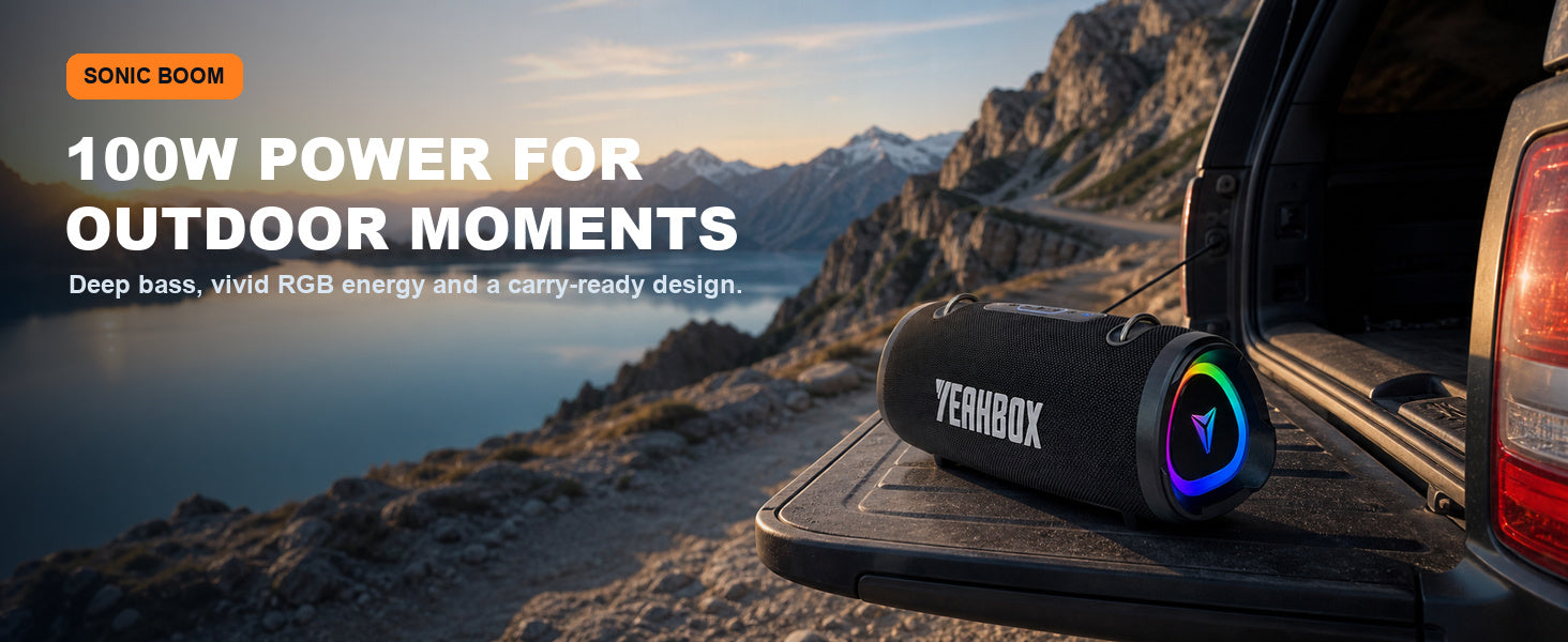 Black Sonic Boom 100W speaker at a mountain overlook beside an open vehicle