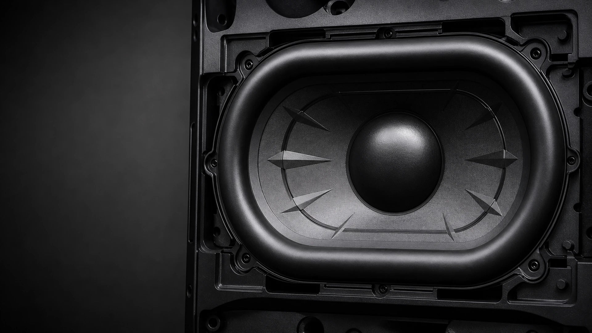 Macro view of the Ultra K horizontal 230 by 165 millimeter racetrack woofer mounted in its black baffle